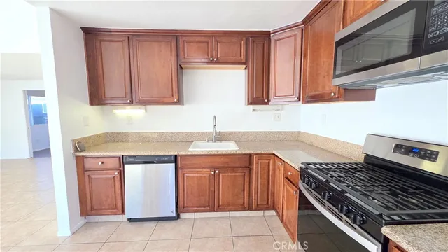 a kitchen with a sink stove top oven and cabinets