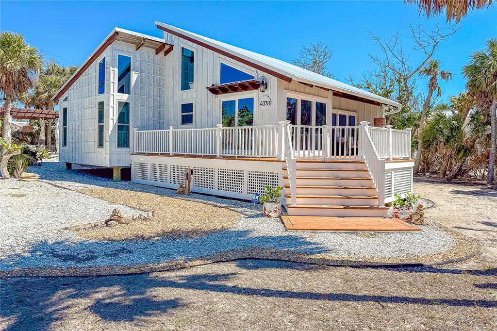 4078 North Beach Road Englewood, FL 34223 - Photo 1 of 1 a front view of a house with a yard