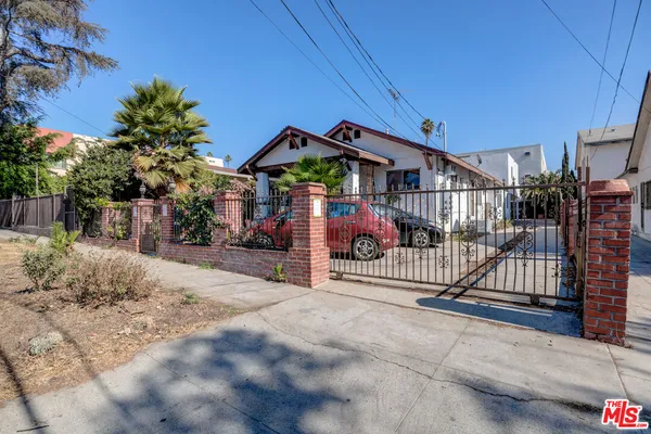a view of a wrought iron fences in front of house
