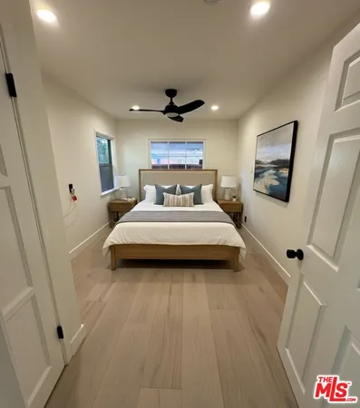 a spacious bedroom with a bed and a chandelier