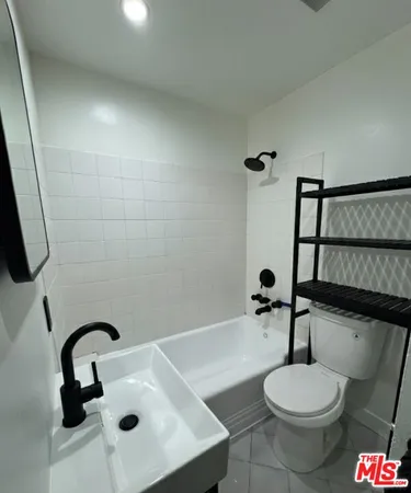 a bathroom with a sink toilet and a mirror