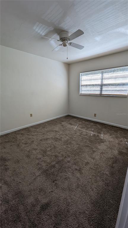3924 Southwest 26th Drive, Unit 5 Gainesville, FL 32608 - Photo 8 of 9 an empty room with a empty space and windows