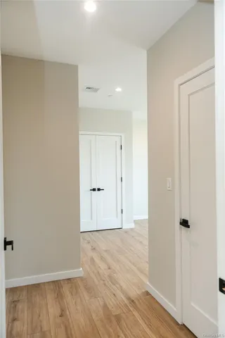a view of an empty room and wooden floor
