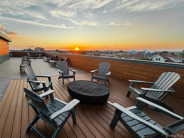 a balcony with wooden floor outdoor seating and city view