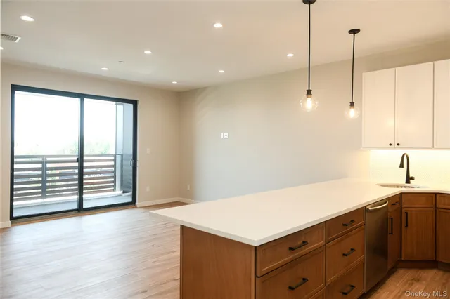a kitchen with a wooden floor and window