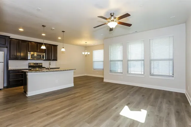 a view of kitchen with sink and wooden floor