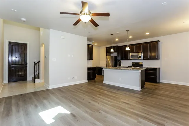 a view of kitchen with refrigerator stove microwave and cabinets