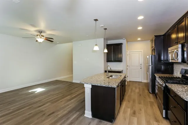 a view of kitchen with cabinets appliances and wooden floor
