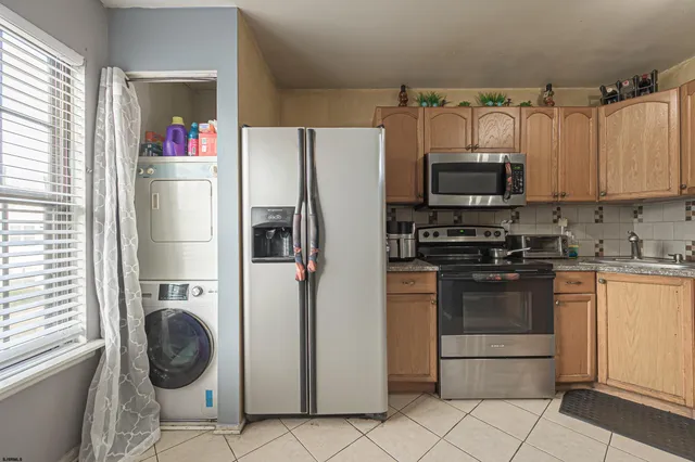 a kitchen with stainless steel appliances a refrigerator sink and microwave