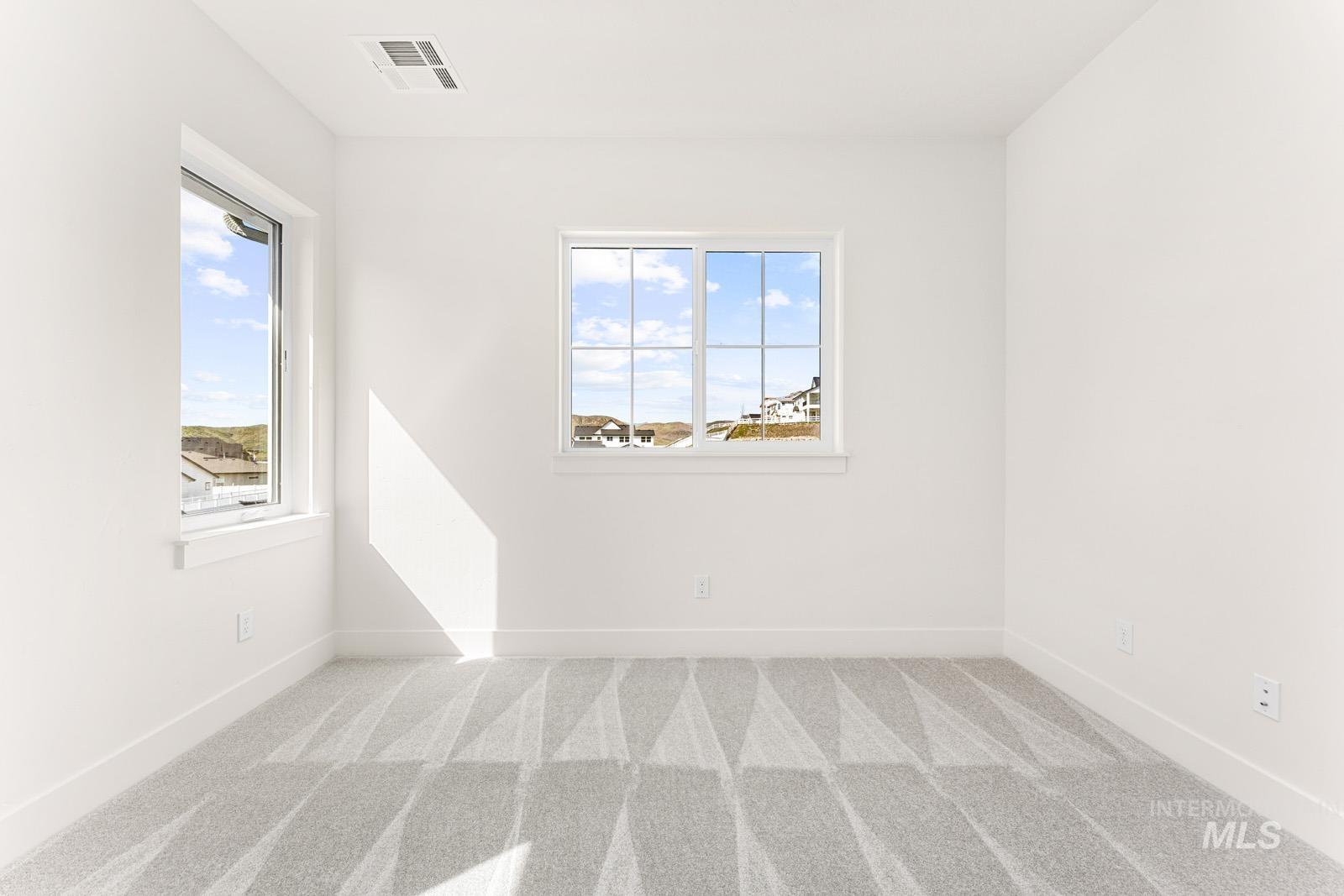 13344 North Spring Creek Way Boise, ID 83714 - Photo 22 of 39 Spare room with light colored carpet and baseboards