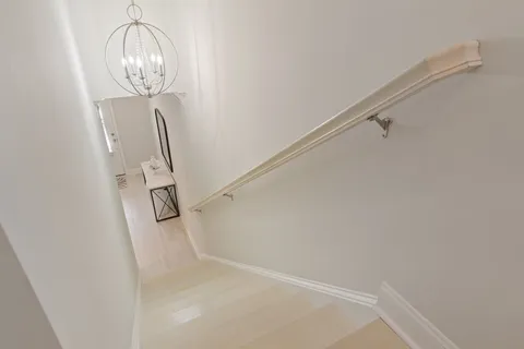 a living room with furniture and chandelier