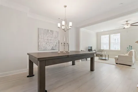 a view of a room with a table and chairs