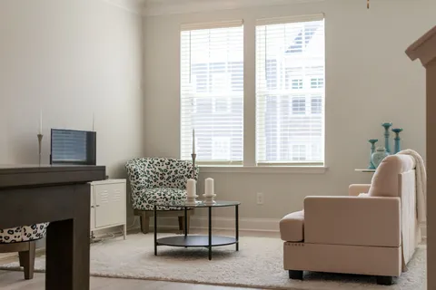 a living room with furniture and a chandelier