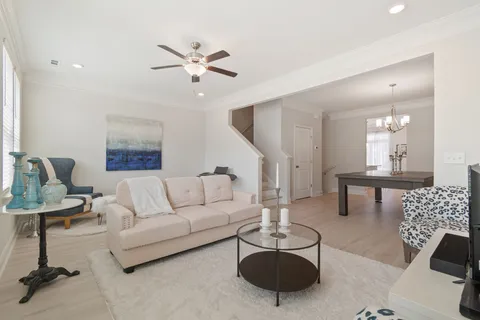 a kitchen with a dining table chairs and white cabinets
