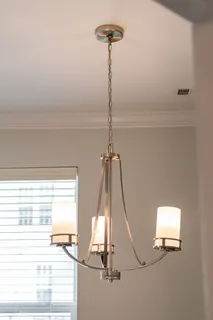 a kitchen with stainless steel appliances granite countertop a refrigerator sink and white cabinets