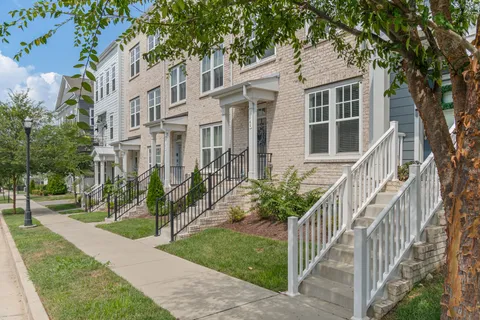 a view of a hallway with wooden floor and entryway