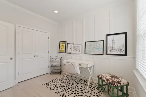 a room with table chairs and wooden floor