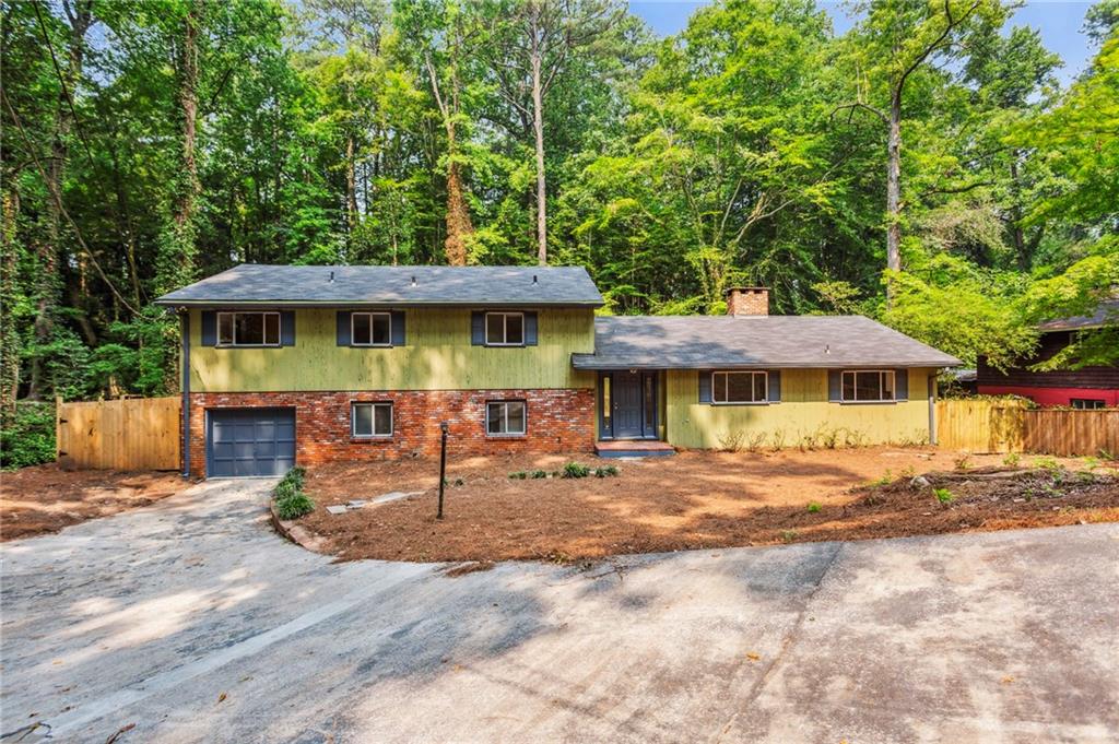 a view of a house with backyard and sitting area