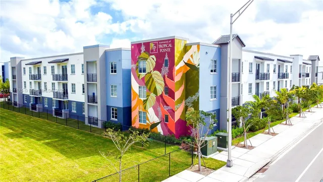 a view of houses with door and yard