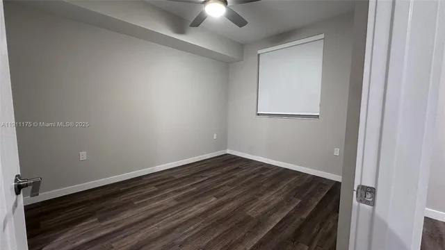 a view of room with hardwood floor and ceiling fan