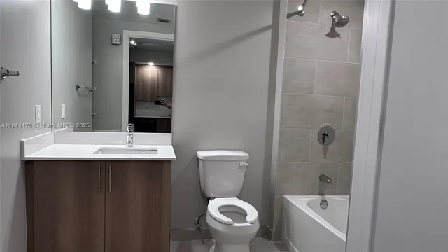 a bathroom with a sink and mirror with toilet