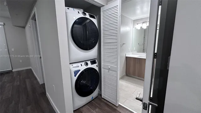 a view of a hallway with washer and dryer