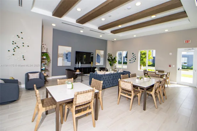 a dining room with wooden floor a glass table and chairs