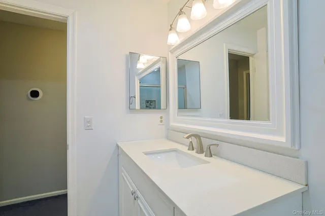 a bathroom with a sink and a mirror