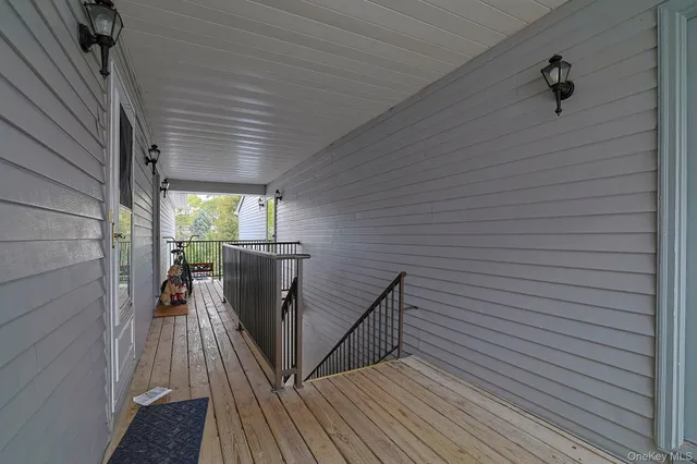 a view of a balcony with furniture and wooden floor