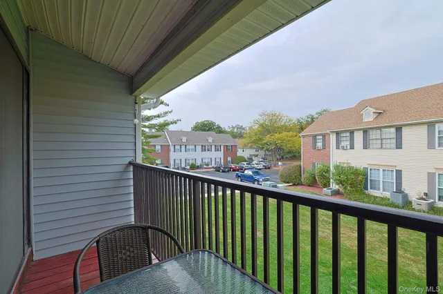 a view of a balcony with wooden floor