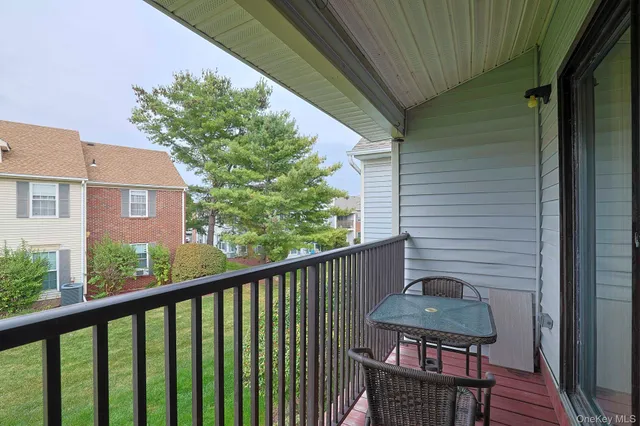 a view of a balcony with chairs