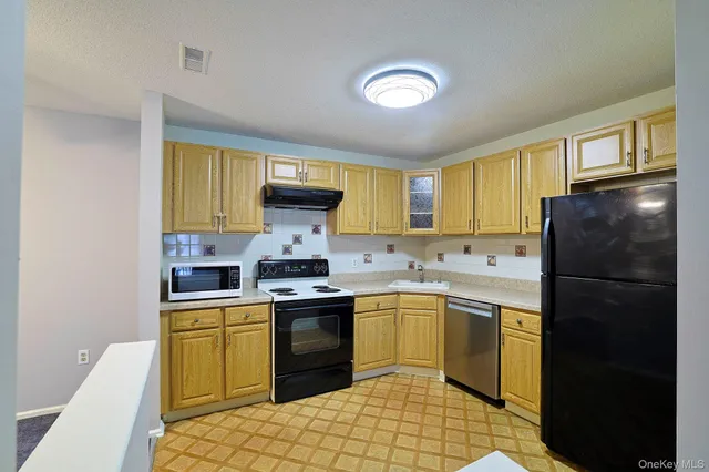 a kitchen with a sink a stove and refrigerator