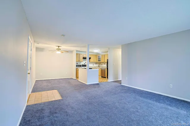a view of kitchen with refrigerator and window