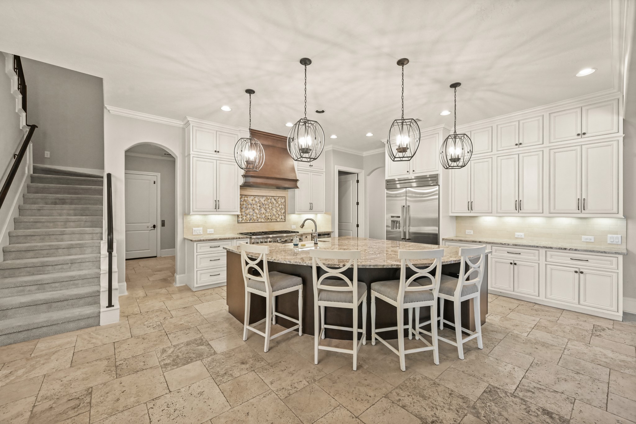 27322 Silver Jade Court Spring, TX 77386 - Photo 11 of 45 Gourmet kitchen featuring a large granite island, travertine floors, Thermador appliances, a 6-burner gas range, and a spacious walk-in pantry.