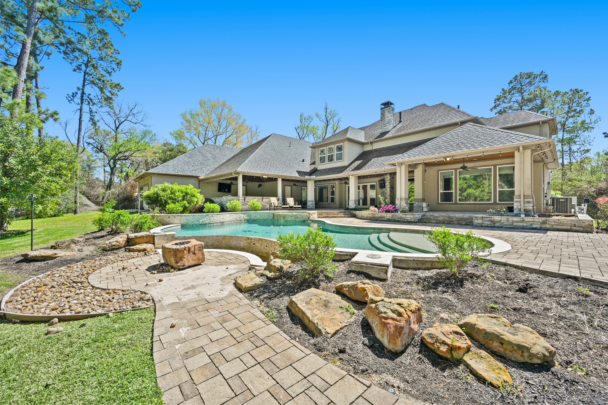 27322 Silver Jade Court Spring, TX 77386 - Photo 2 of 45 Private, expansive covered patio with outdoor kitchen that has granite countertops, grill, mini fridge and sparkling pool/spa.