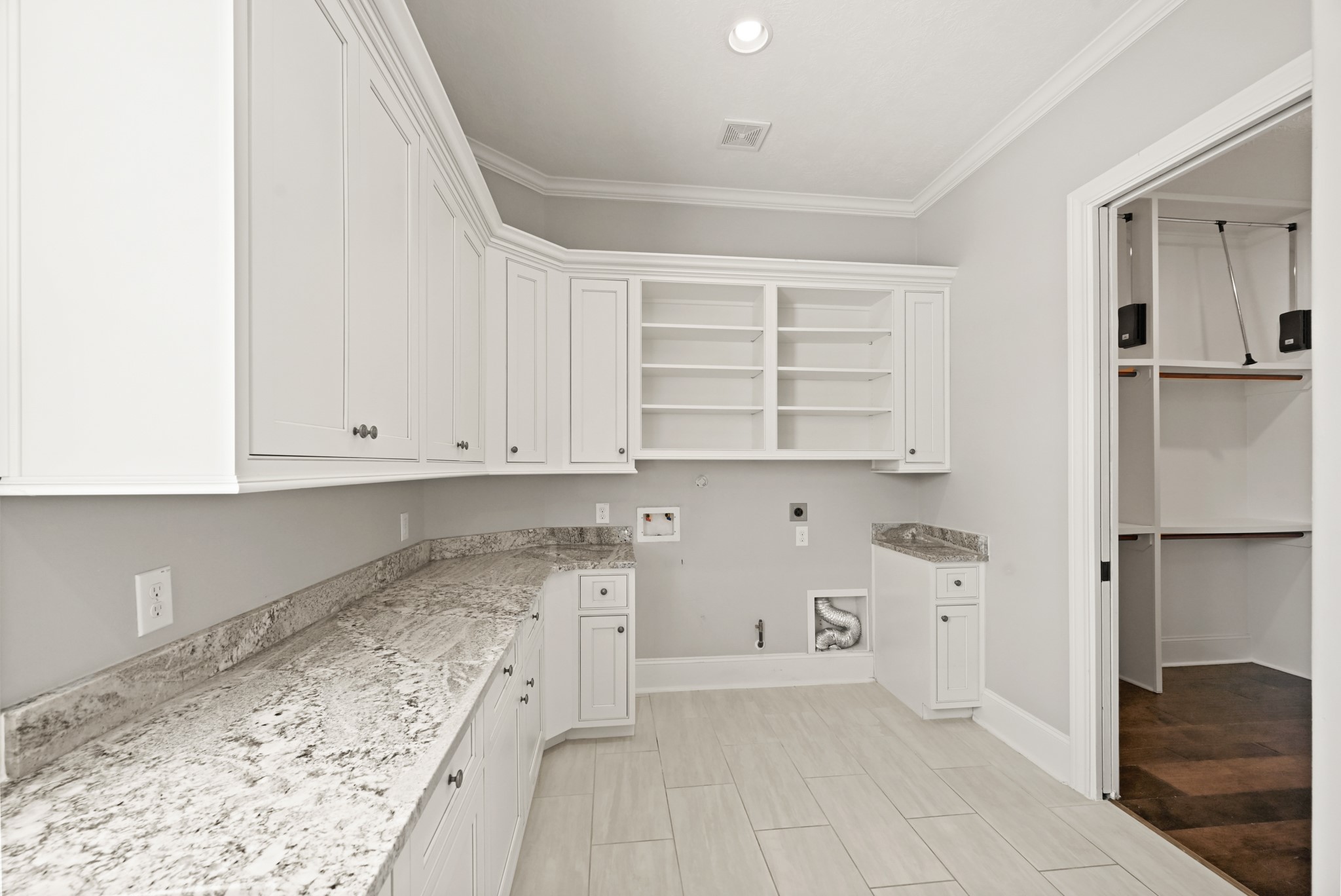 27322 Silver Jade Court Spring, TX 77386 - Photo 20 of 45 Downstairs laundry room opens directly to the primary walk-in closet and includes a convenient built-in ironing board.