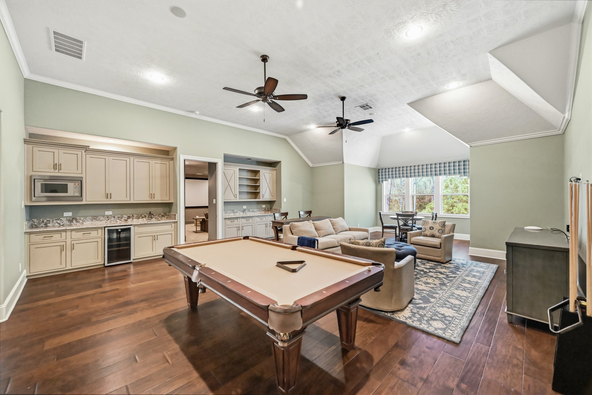 27322 Silver Jade Court Spring, TX 77386 - Photo 25 of 45 Large upstairs game room with plenty of space for a pool table, sitting area, and card table, plus a built-in kitchenette with microwave and mini-fridge.