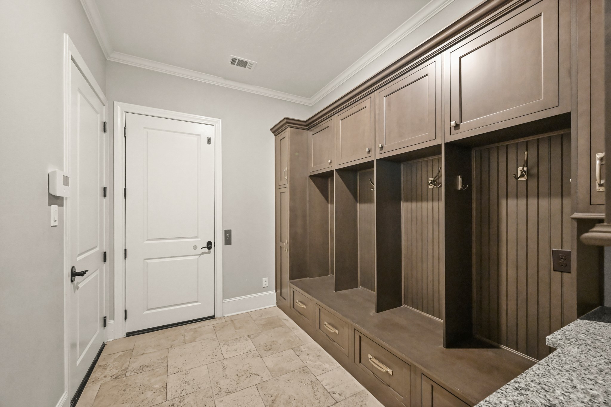 27322 Silver Jade Court Spring, TX 77386 - Photo 35 of 45 Mud room features built-ins and travertine flooring as you enter from the garage.