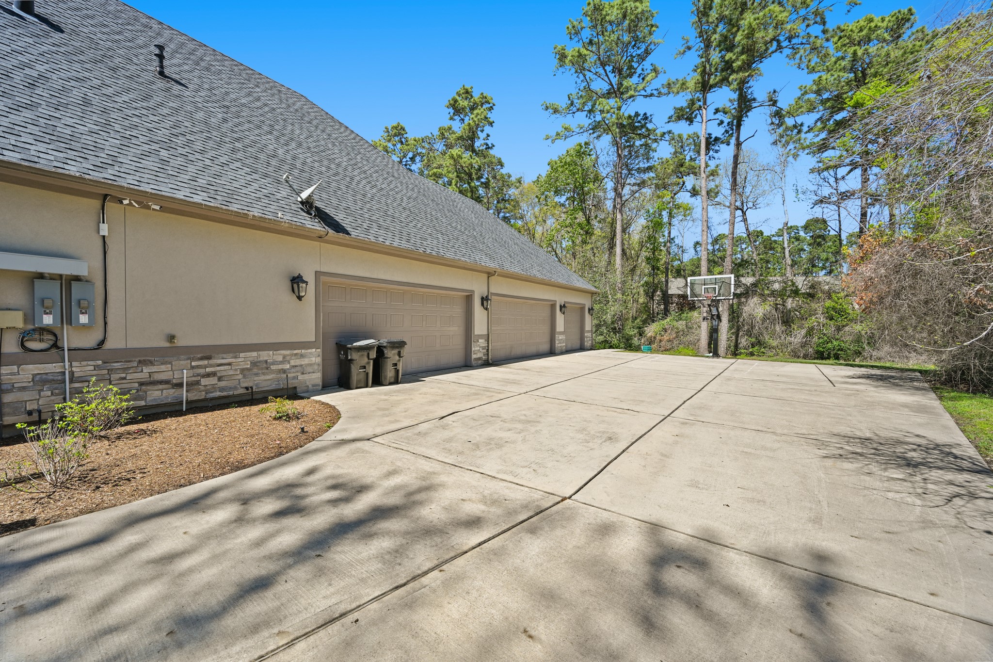 27322 Silver Jade Court Spring, TX 77386 - Photo 36 of 45 Oversized 5 car garage with workspace, batting cage and basketball hoop! Whole house generator and also wheelchair accessible from garage.