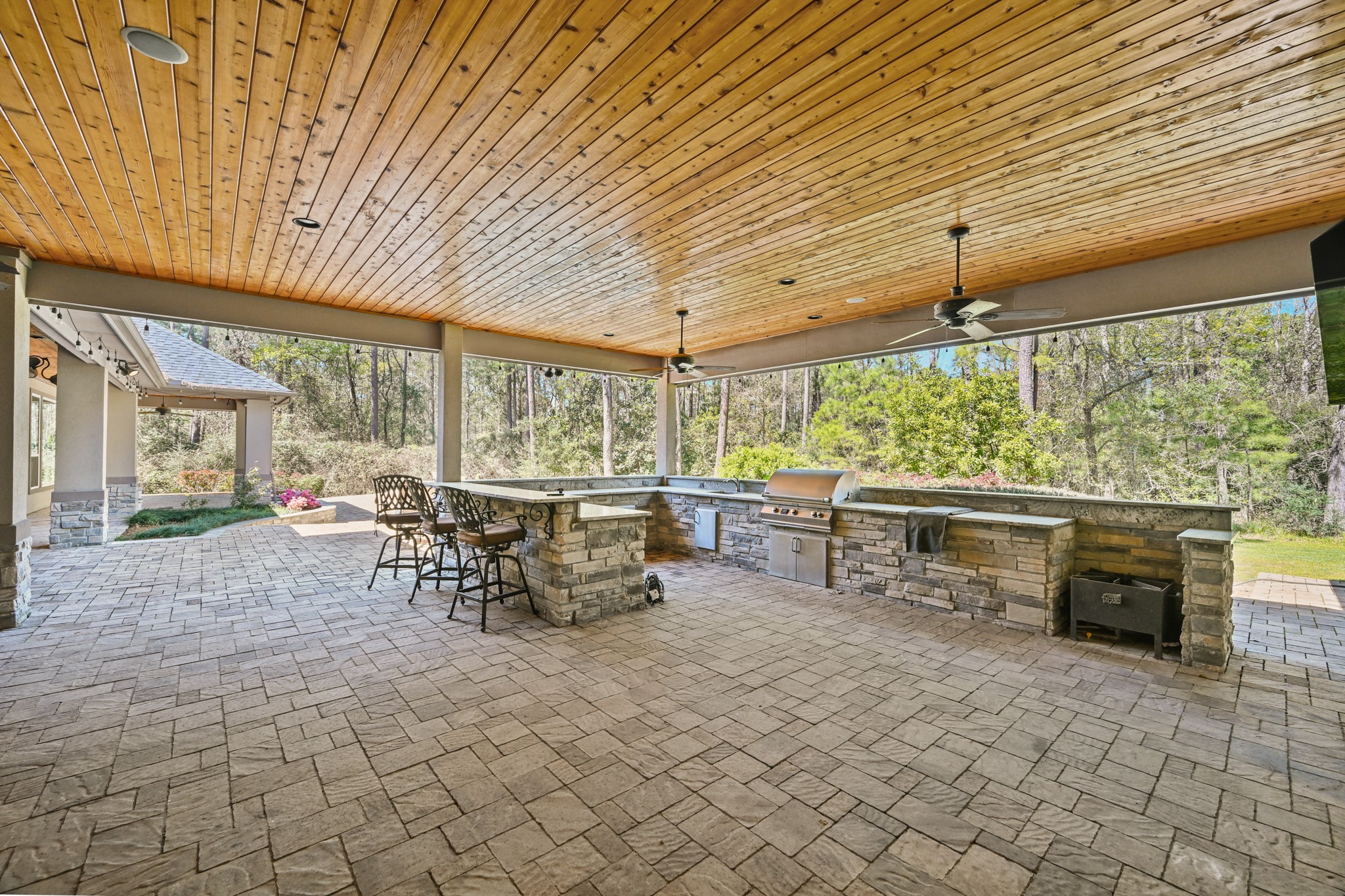 27322 Silver Jade Court Spring, TX 77386 - Photo 41 of 45 Outdoor living at its finest with a complete outdoor kitchen featuring a grill, mini-fridge, and bar seating.