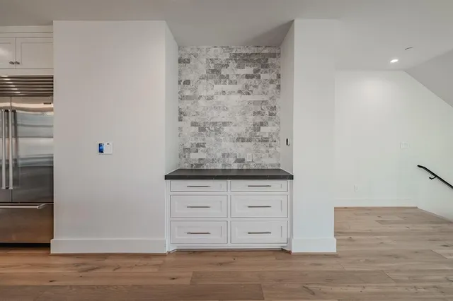 a view of kitchen with granite countertop cabinets and window