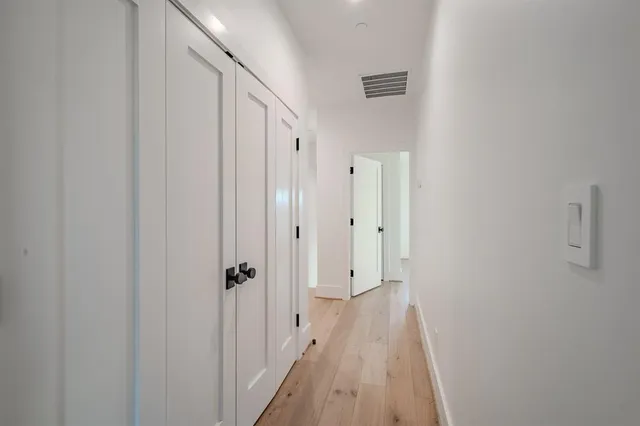 a view of a room with wooden floor