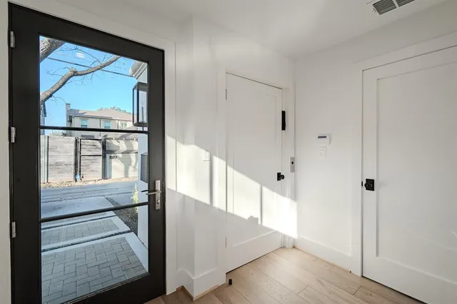 a view of a hallway with wooden floor and entryway