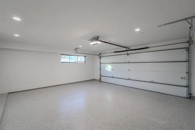 an empty room with windows and ceiling fan