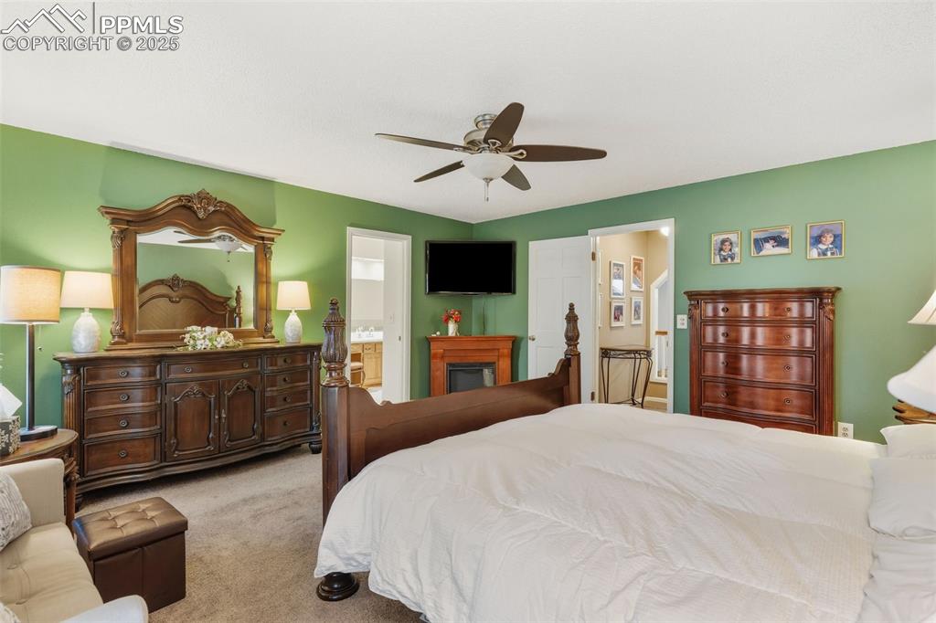 2005 Windham Way, Unit 8 Colorado Springs, CO 80906 - Photo 14 of 35 a bedroom with a bed and a dresser
