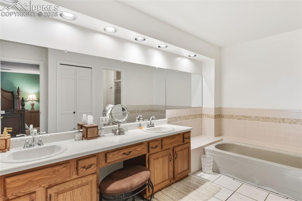 2005 Windham Way, Unit 8 Colorado Springs, CO 80906 - Photo 15 of 35 a bathroom with a tub double sink and mirror