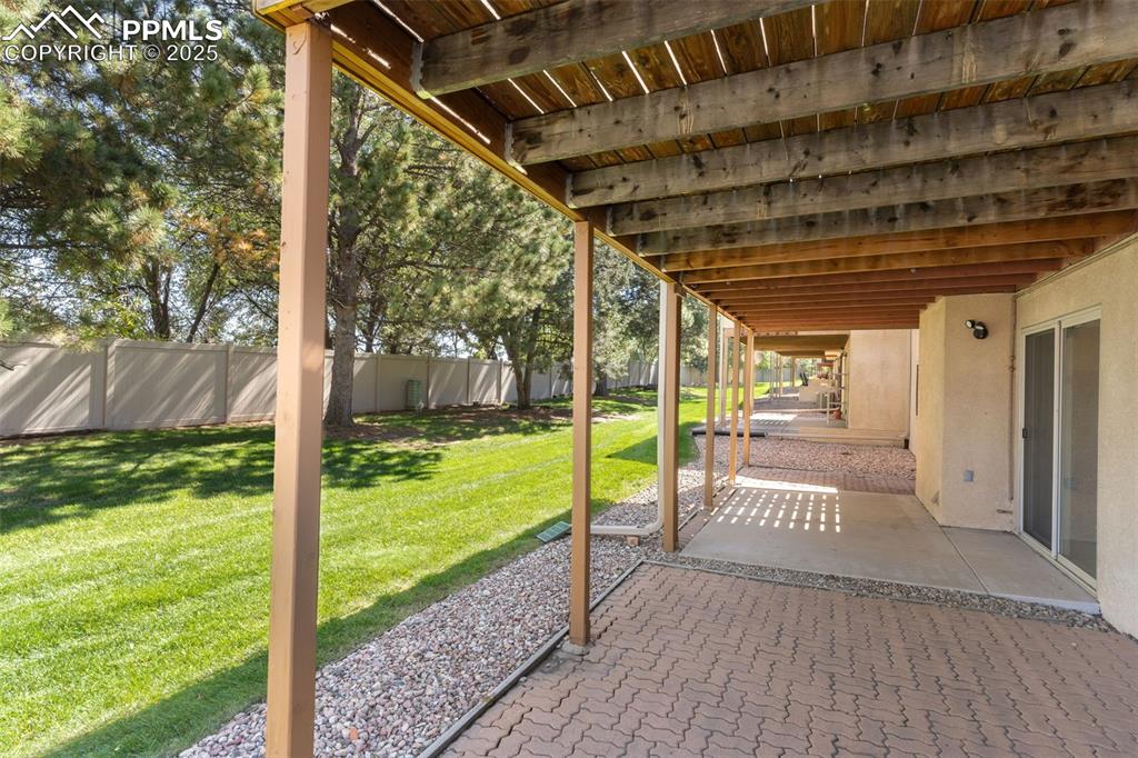 2005 Windham Way, Unit 8 Colorado Springs, CO 80906 - Photo 19 of 35 a view of a porch with wooden floor and fence