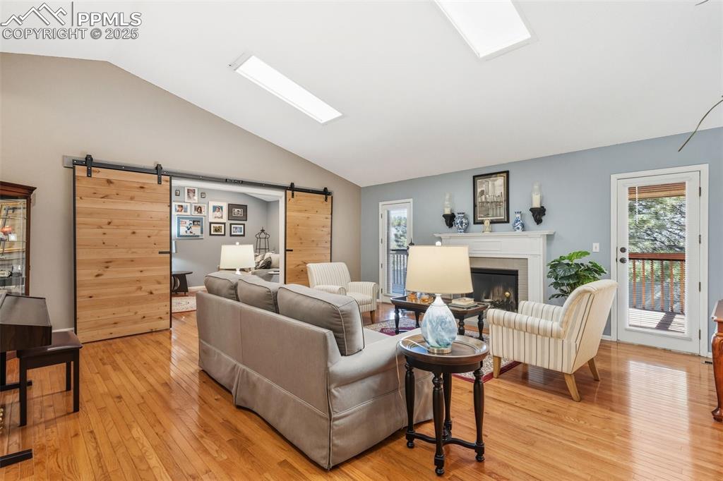 2005 Windham Way, Unit 8 Colorado Springs, CO 80906 - Photo 3 of 35 a living room with furniture a fireplace and a floor to ceiling window