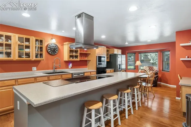 a kitchen with stainless steel appliances a sink and a large window