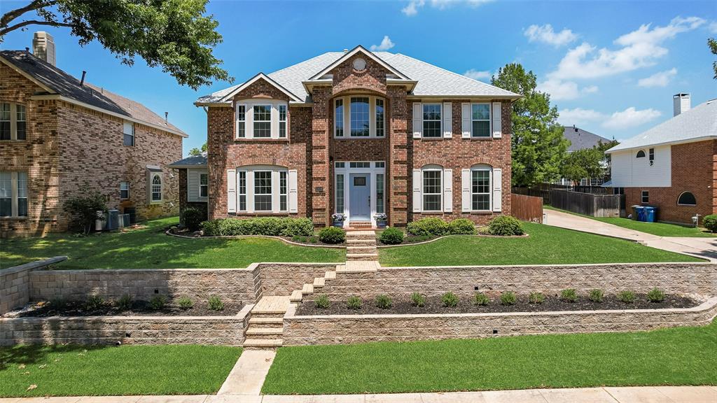 1406 West Peters Colony Road Carrollton, TX 75007 - Photo 1 of 29 a front view of a house with a yard